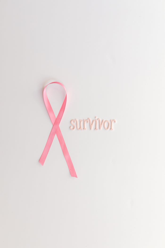 services-01 Pink ribbon symbolizing breast cancer awareness on a white background with the word 'survivor'.